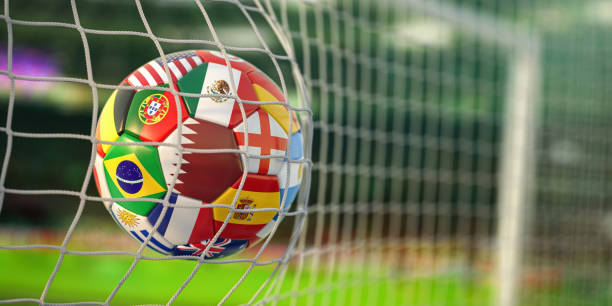 Soccer football ball with flags of world countries scoring goal on a cup of world. stock photo