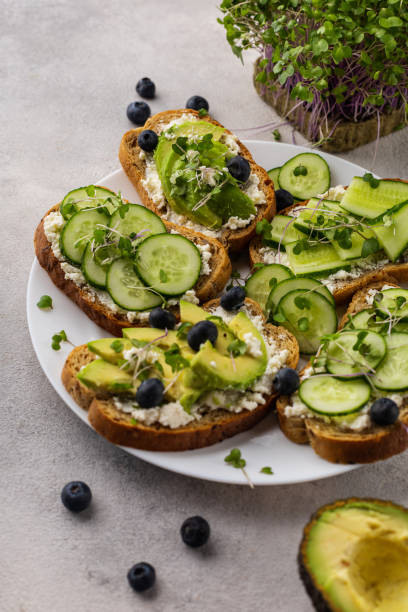istock Vegetarian green sandwiches with avocado and cucumber with microgreens on a light background 1431739206