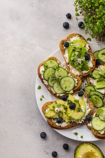 istock Vegetarian green sandwiches with avocado and cucumber with microgreens on a light background 1431739207