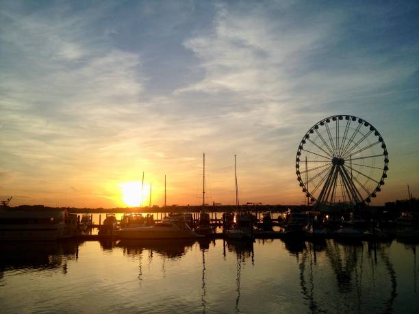 istock Sunset over the water with a Ferris wheel 1431739358