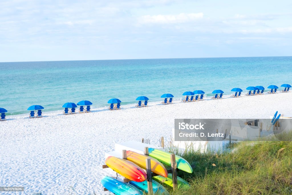 Seaside Beach Florida A row of blue beach chairs with umbrellas sitting on the white sand beaches of Seaside beach in Flroida, in front of the ocean. Clearwater - Florida Stock Photo