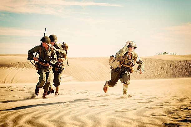 WWII Medic and Soldiers Running from Enemy Fire stock photo
