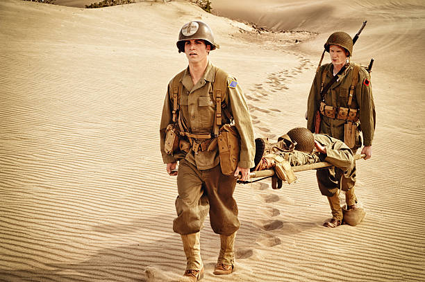 istock WWII Medic and Soldier Evacuating Wounded Man On Litter 143174493
