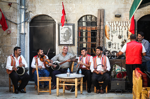 Istanbul, Turkey - June 20, 2022: Musicians play guitar, clap, and sing, busking on stiklal Avenue in the Taksim area of Istanbul.