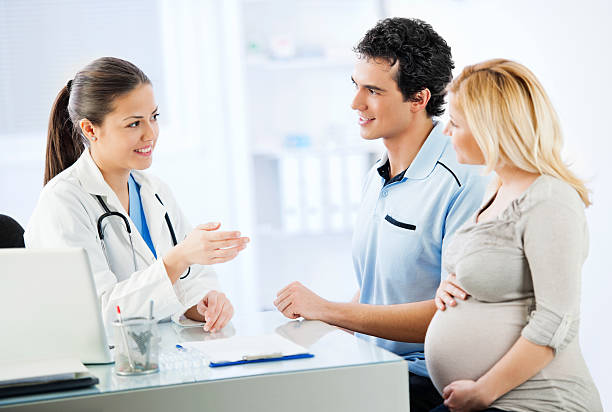 istock Young cheerful couple visiting a doctor 143174572