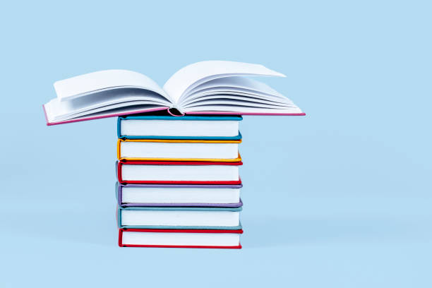 istock Stack of books on light blue background. Front view, copy space fot text or product. Education, back to school concept 1431746312
