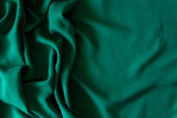 istock Abstract linen blend wavy fabric texture background. Crumpled dark green hue dyed linen textiles canvas background. Top view 1431746338