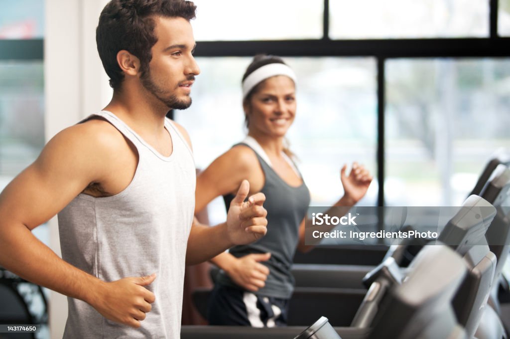 Cheerful smiling and beautiful people running at the fitness club. Active Lifestyle Stock Photo