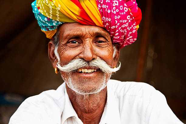 senior man portrait in Pushkar, India senior man with colorful turban, cattle fair in Pushkar, Rajasthan, India market vendor photos stock pictures, royalty-free photos & images