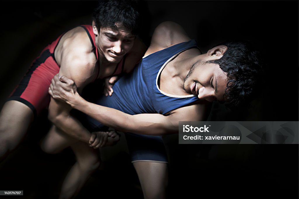 Indian wrestling Low key of two indian wrestlers in combat. Wrestling Stock Photo