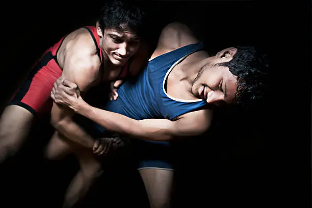 Low key of two indian wrestlers in combat.