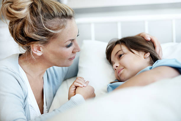 Comforting touch of a mother  sick child hospital bed stock pictures, royalty-free photos & images