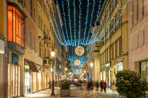 Amazing Christmas week -  street view in Parma.  People - move blurred and Christmas illuminated