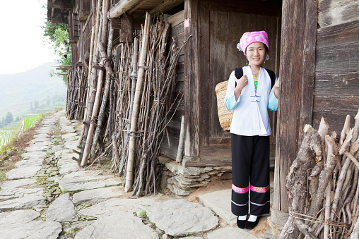Zhuang tribe girl preparing to work in the rice field,Longsheng,Guilin,Guangxi,China.