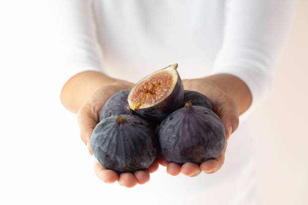 istock Woman Showing Fresh Figs 1431750597