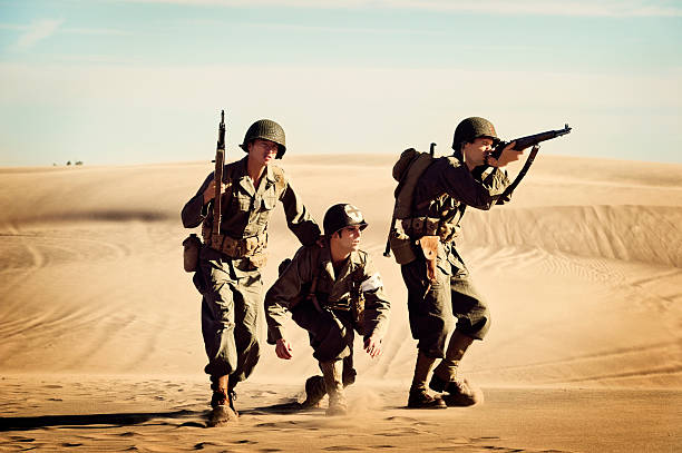 istock Two WWII Soldiers Protecting The Squad Medic 143175171
