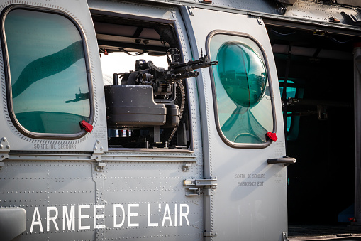Machine gun in a side window of the Airbus Helicopters H225M helicopter from the French Air Force. Le Bourget, France - June 22, 2017