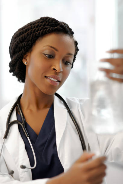 istock Beautiful ethnic doctor checking intravenous 143175410