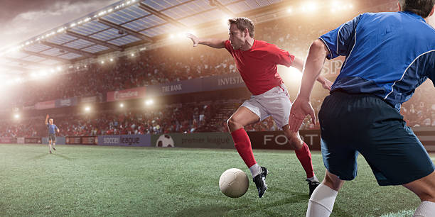 Soccer Action professional football players in floodlit stadium football socks stock pictures, royalty-free photos & images