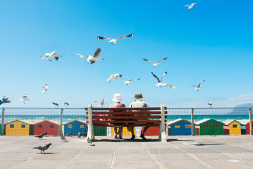 A senior couple enjoy lunch at Muizenberg Beach in Cape Town.