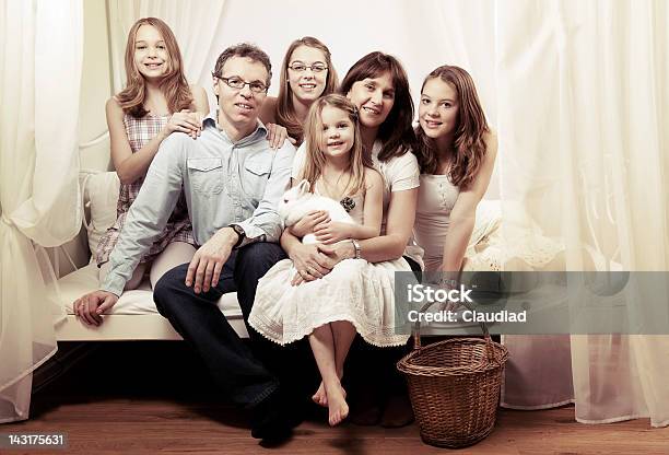 Happy Family Sitting On Bed Stock Photo - Download Image Now - Bed - Furniture, Front View, Full Length