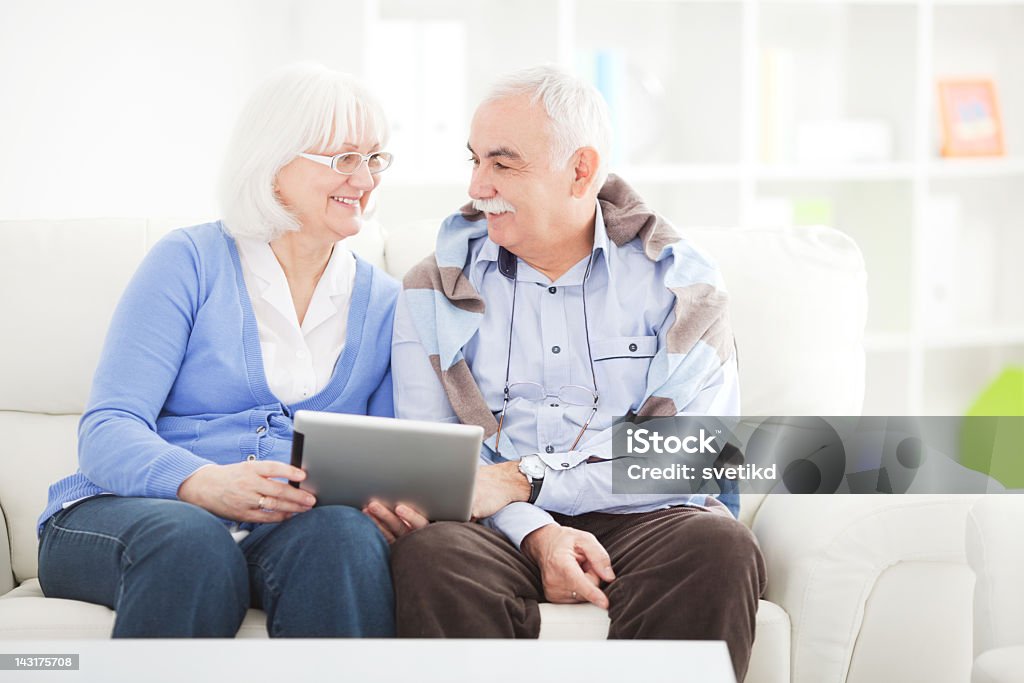 Senior couple with tablet.  60-64 Years Stock Photo