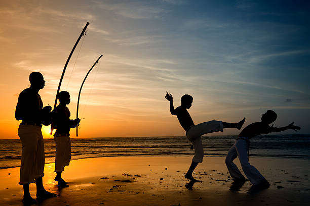 Capoeira and berimbau player Capoeira, the Brazilian martial art that combines elements of dance and music. It was created in Brazil mainly by descendants of African slaves with Brazilian native influences,probably beginning in the 16th century. It is known by quick and complex moves, using mainly power, speed, and leverage for leg sweeps. northeastern brazil stock pictures, royalty-free photos & images