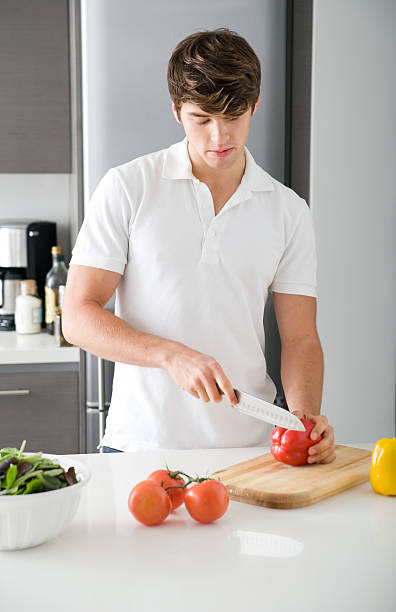 Young man cooking stock photo