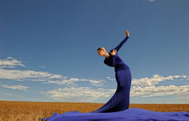 Lady in large evening dress against sky landscape  haute couture stock pictures, royalty-free photos & images