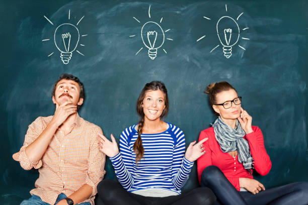 Designers in front of a blackboard.