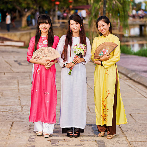 Portrait of three young Vietnamese women wearing ao dai  ao dai stock pictures, royalty-free photos & images