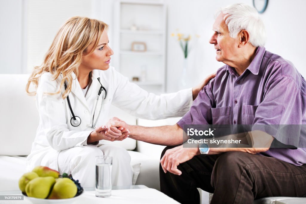 Female doctor examining an elderly patient.  Doctor Stock Photo