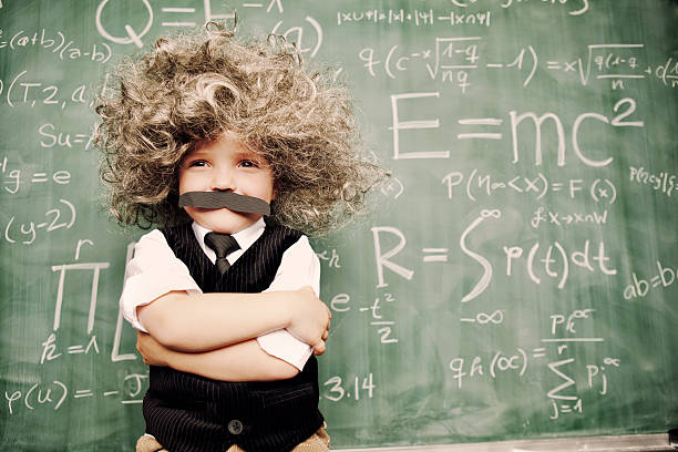 Little Mr. Smarty Pants A young math whiz smiles as he has solved the riddles of the universe. projection photos stock pictures, royalty-free photos & images
