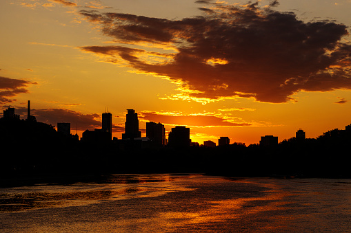 Minneapolis Skyline and Mississippi River silhouette against a cloudy sunset sky.\n\nTaken in Minneapolis. Minnesota, USA