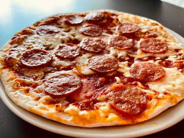 istock Pizza pepperoni on a white plate and black table 1431762474