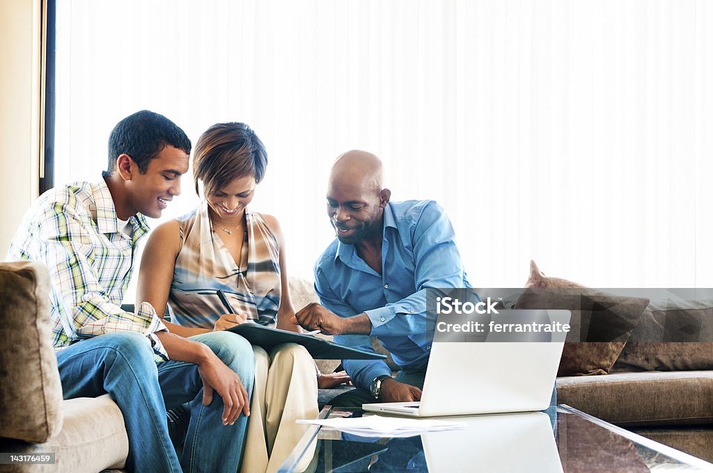 Financial Advisor Young African couple in a meeting with a financial advisor signing documents. Financial Advisor Stock Photo