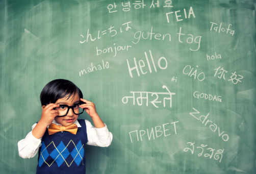 A young Indian language master boy knows how to say hello in many different languages. All languages and cultures are beautiful.