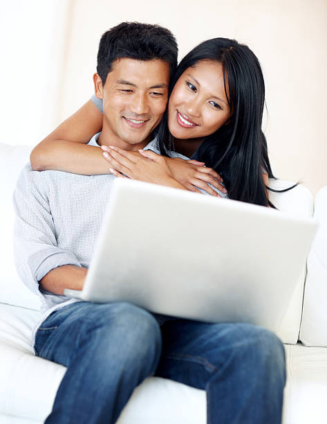 istock Woman holding man while they look at laptop 143176489