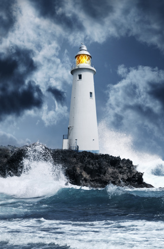 The Cap Frehel lighthouse, overhanging the cliff, facing the setting sun