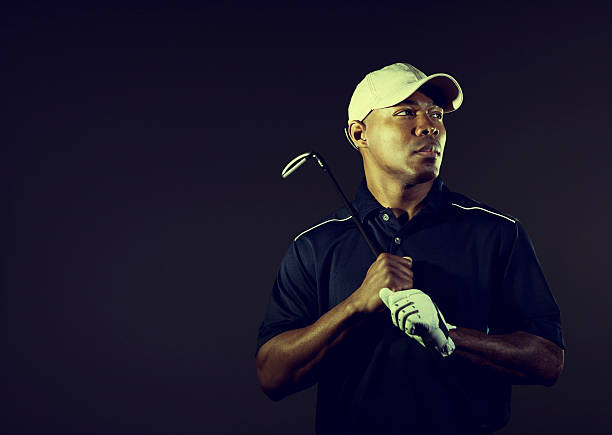 Male Golfer Portrait of an African American golfer. Vintage processing. night golf stock pictures, royalty-free photos & images