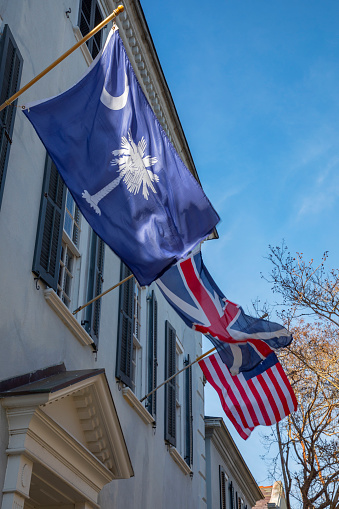 South Carolina state flag flying with the British Union Jack and the United States flag Old Glory in Charleston South Carolina.