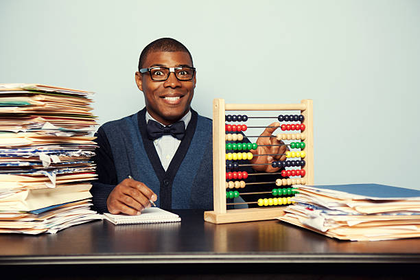 Nerdy Accountant This accountant is old school. His skills with the abacus are unprecedented. black nerd stock pictures, royalty-free photos & images