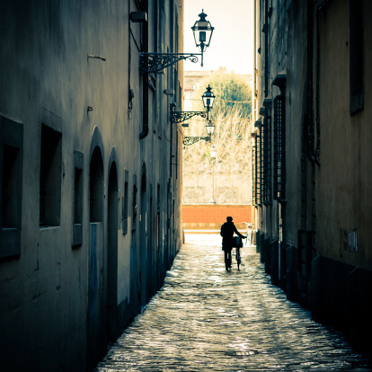 Ancient dark alleyway in Firenze (Tuscany, Italy). Bit of grain added for the mood.