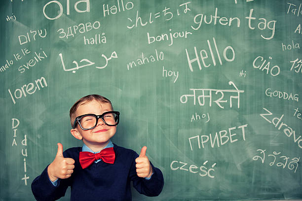 Language Master A young language master boy knows how to say hello in many different languages. All languages and cultures are beautiful. nerd kid stock pictures, royalty-free photos & images