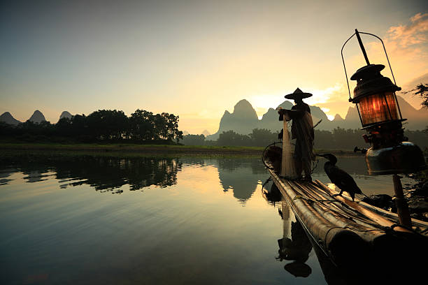 A fisherman on the li river at sunset stock photo