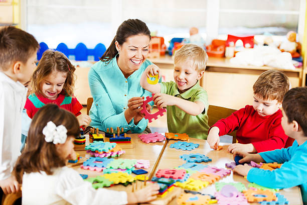 istock Nursery teacher playing with the kids. 143176846