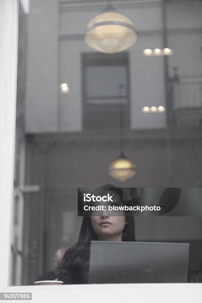 Woman Using An Ultrabook In A Coffee Shop Stock Photo - Download Image Now - Adult, Adults Only, Asian and Indian Ethnicities