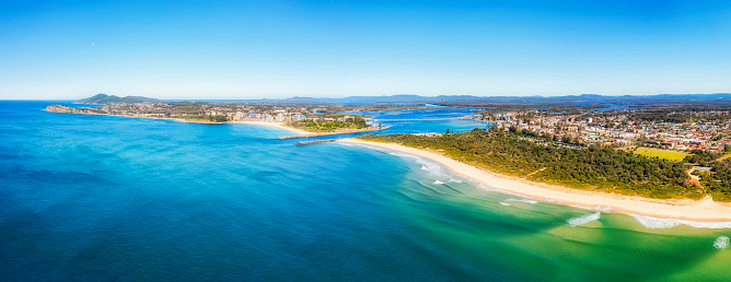Scenic seascape of Nine Mile beach in Forster-Tuncurry towns of Australia on pacific coast - aerial panorama to Wallis lake and river delta.