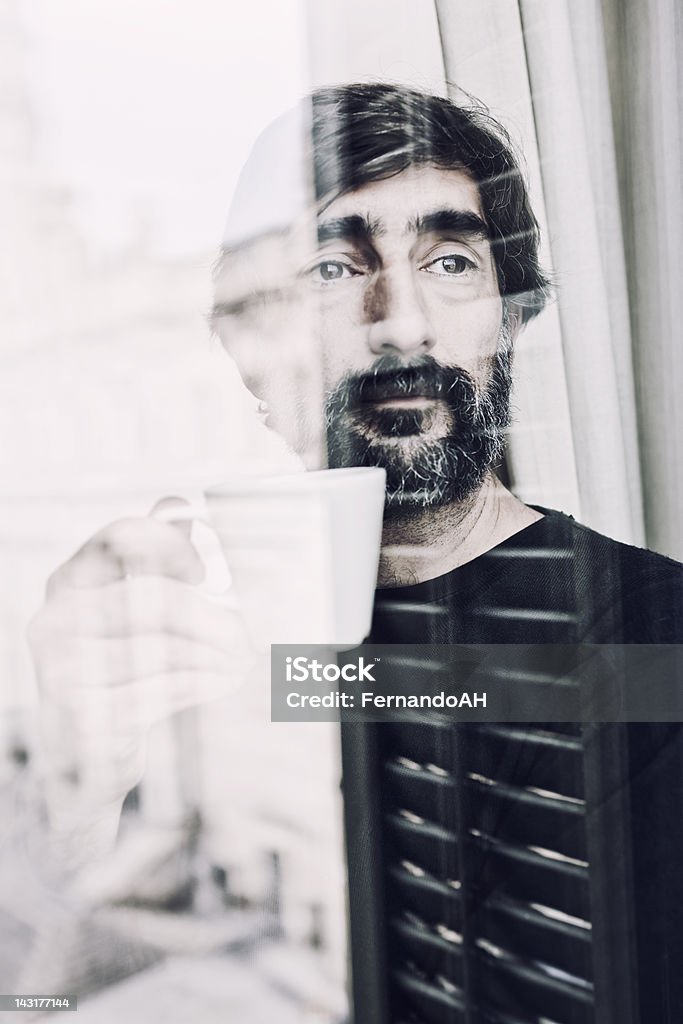 카메라를 향해 미소 짓는 생각에 잠긴 중간 노인 술마시기 커피 루킹 창을 통해 - 로열티 프리 40-44세 스톡 사진