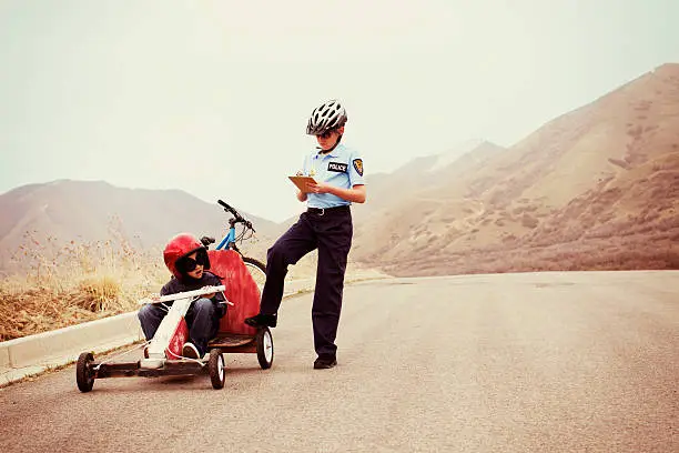 a young boy gets pulled over for speeding in his go-cart.